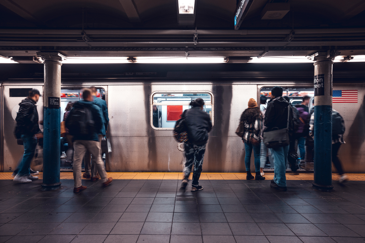 Crowd of people in a NYC subway station waiting for the train