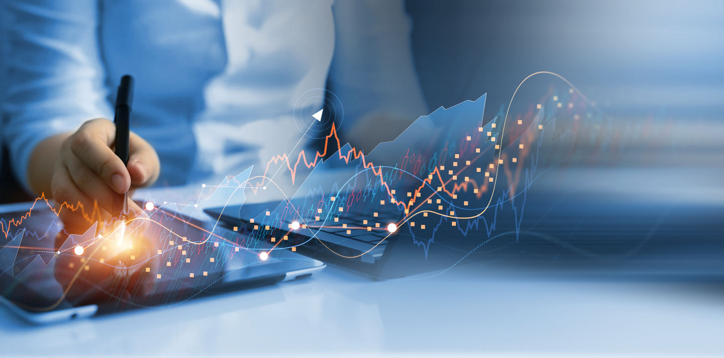 Businessman analyzing data of economic growth graph and progress of business on tablet and laptop.Business development towards success and profitability.