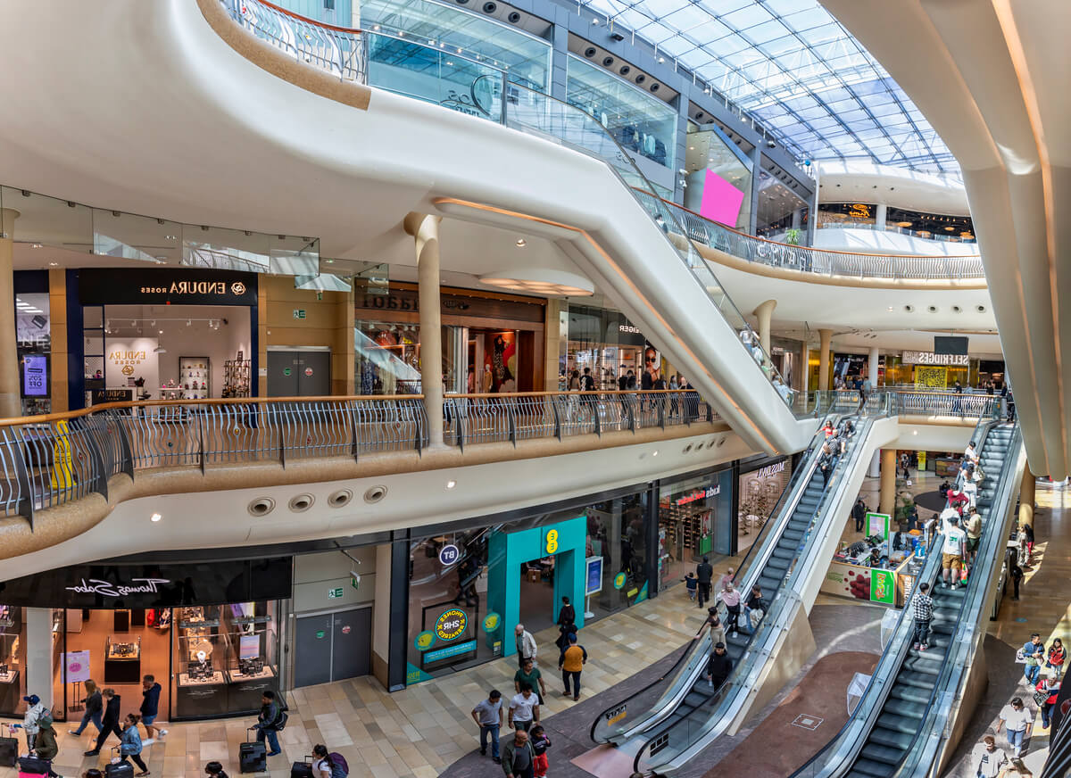 Busy scene with shoppers on escalators inside the Bullring Shopping Mall in Birmingham, West Midlands, UK